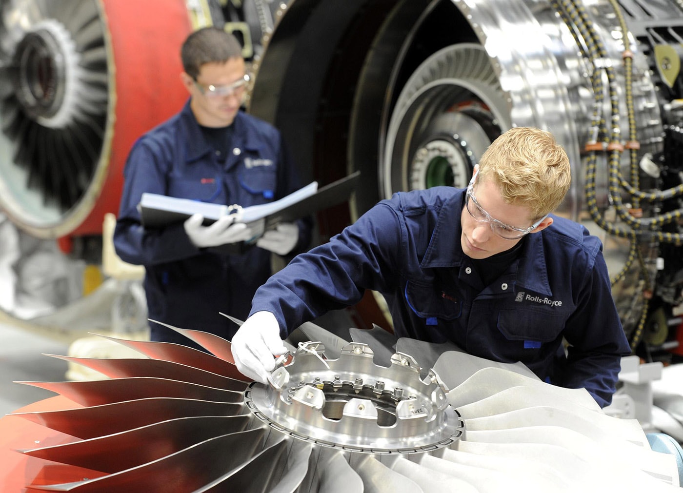 Two people working on aero engine